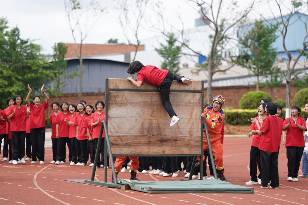 云南麗江華坪女子高級中學(xué)學(xué)生在體驗翻越障礙板。新華社記者陳欣波 攝